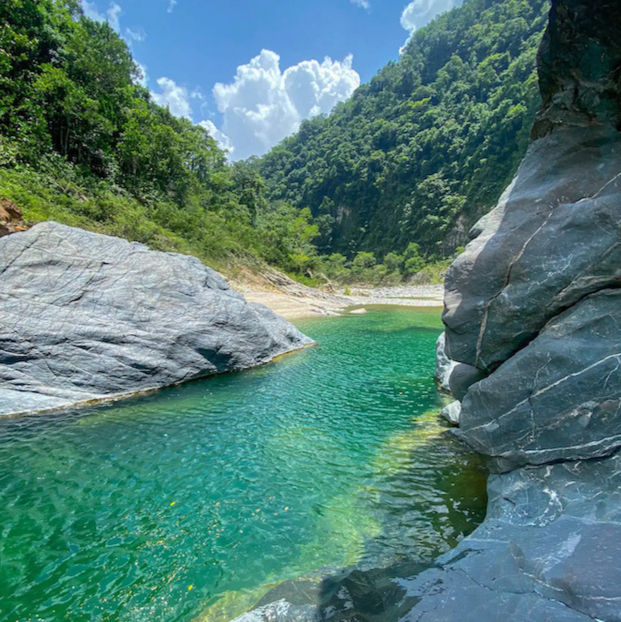 clear natural river within lush green mountain 