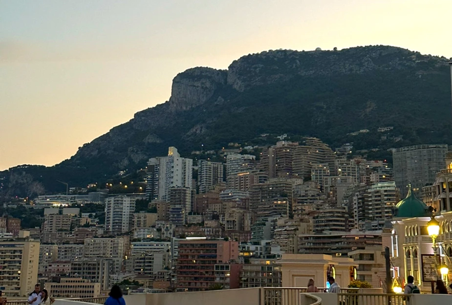 Monte Carlo skyline view at night buildings lit up against mountain