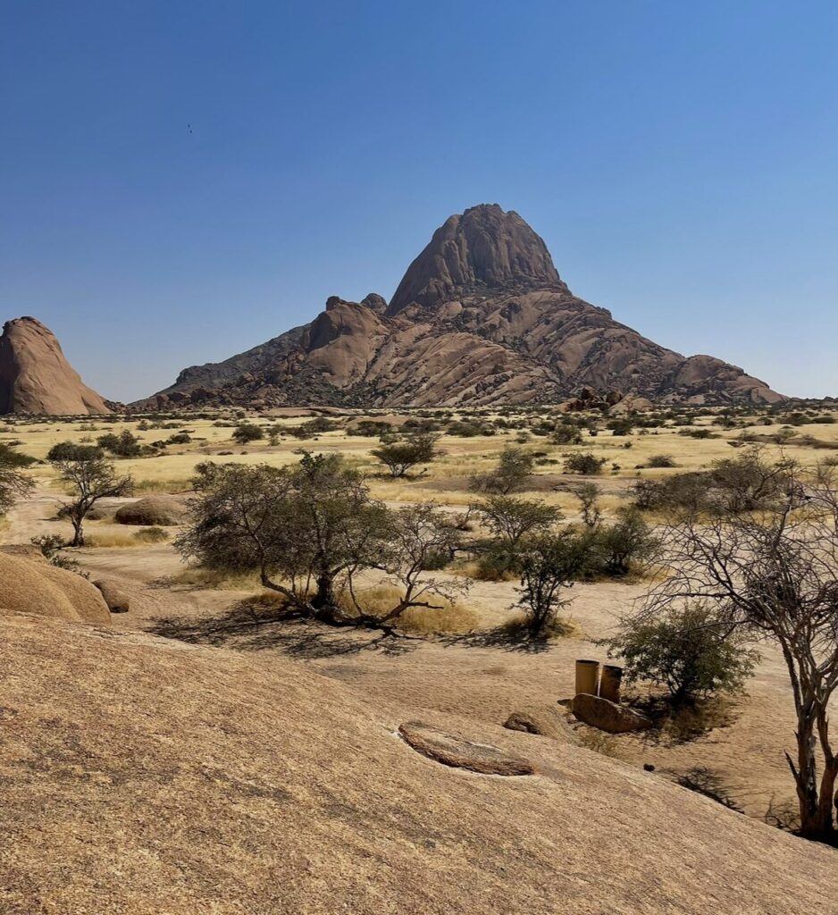 views of towering rocky mountains and savanna fields in spitzkoppe