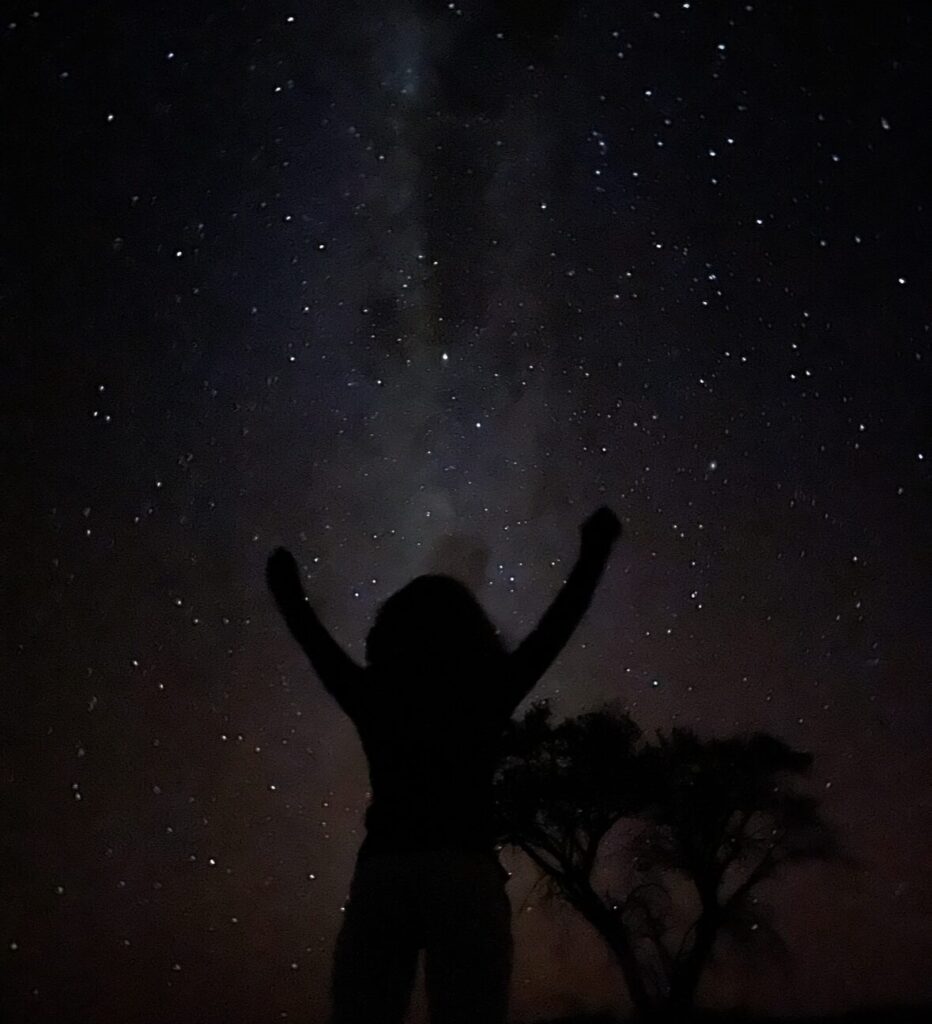 milky way galaxy exposure shot with girl and tree